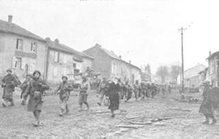 90th Division men passing through Metzervisse on way to front lines.