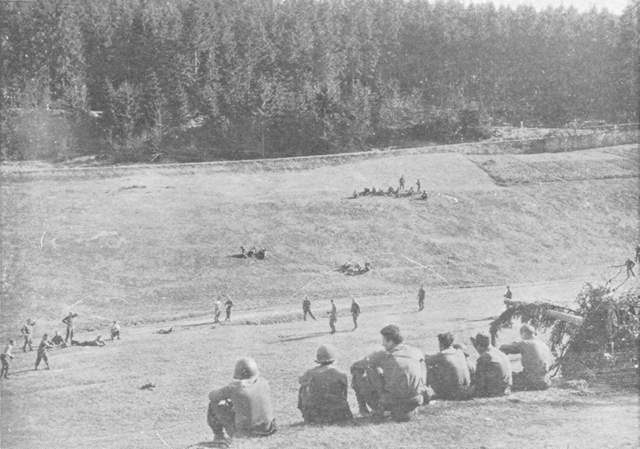 Anti-tank gun and crew guard ball players against a surprise German attack.
