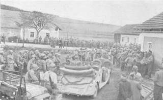 Waiting outside building where German general Weitersheim is making his surrender of the 11th Panzer Division.